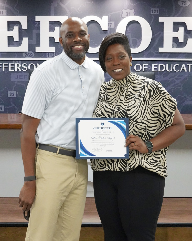 Tinker Rogers and her husband pose for a photo inside the JEFCOED Board Room  