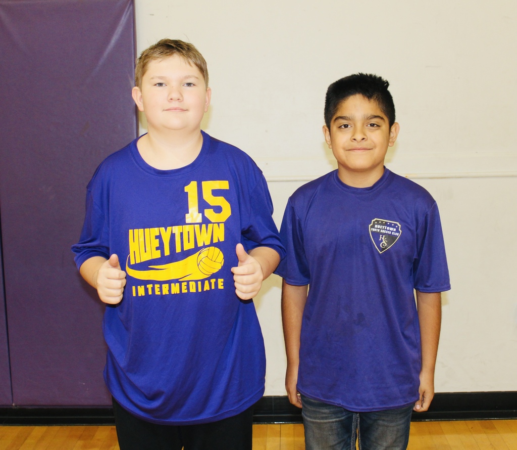 Two HMS students show their school spirit while wearing purple Hueytown athletic shirts.