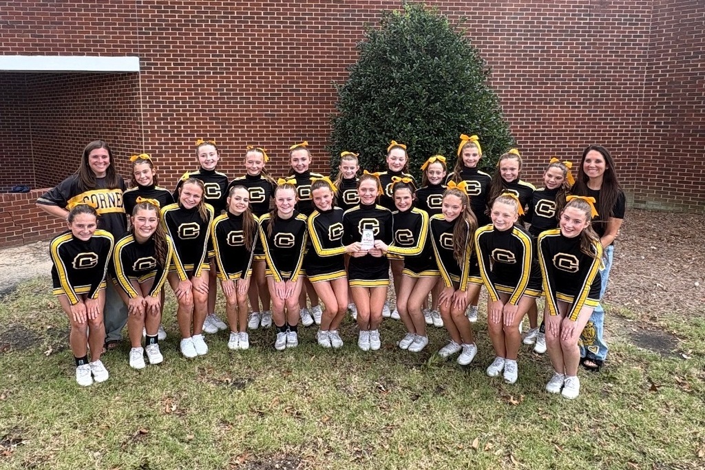 Cheerleaders with a plaque