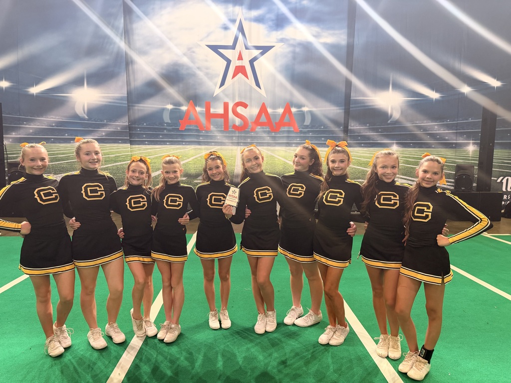 Cheerleaders with a plaque