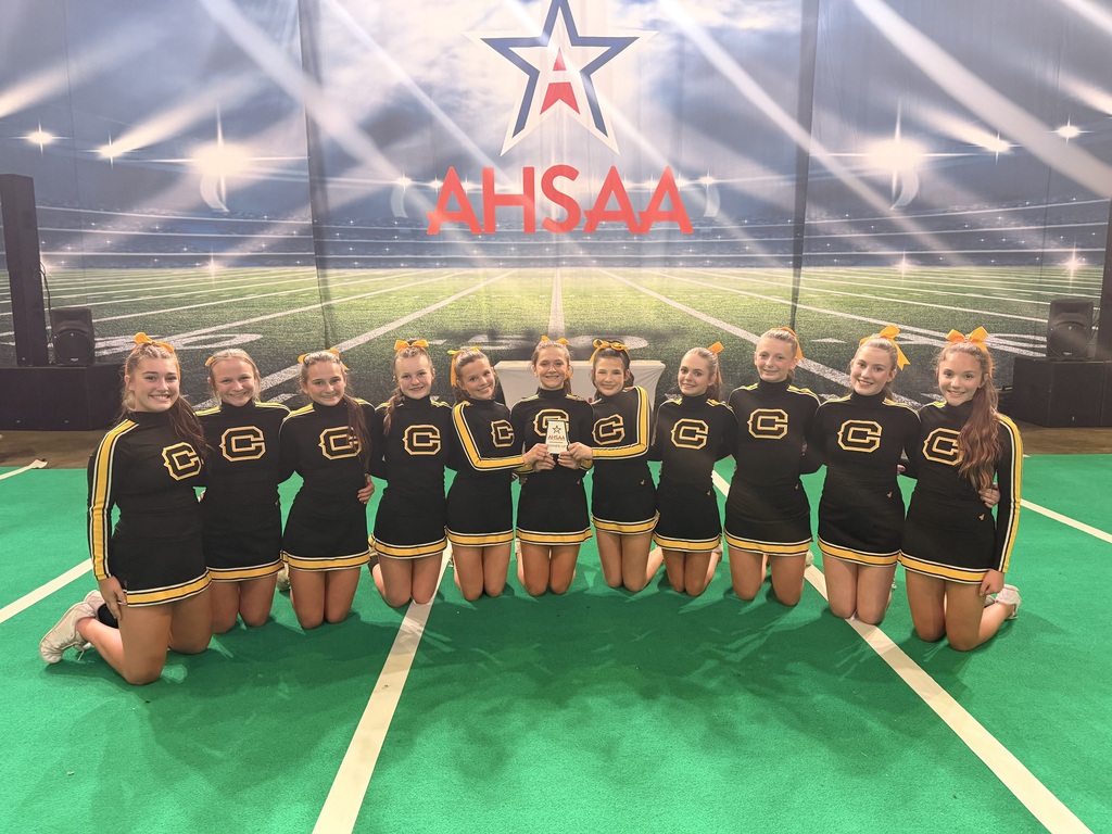 Cheerleaders with a plaque