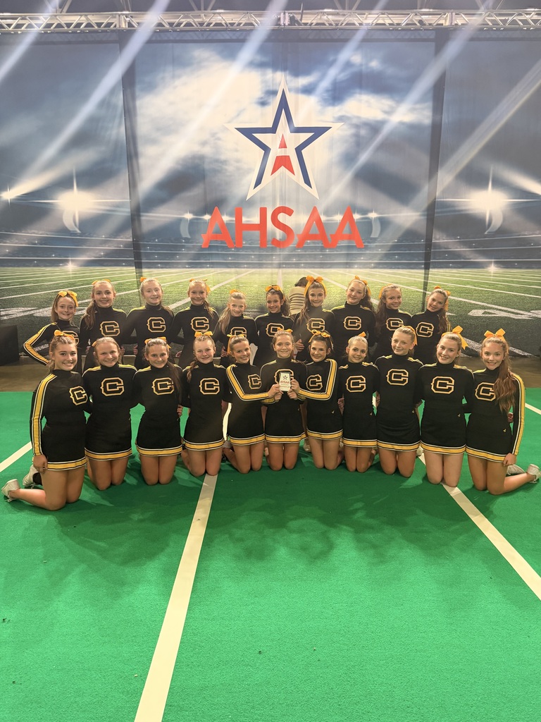 Cheerleaders with a plaque