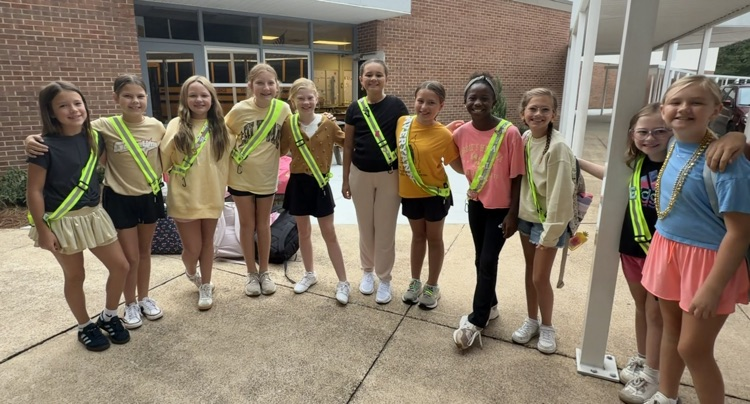 Safety Patrol members in gold posing with arms around each other