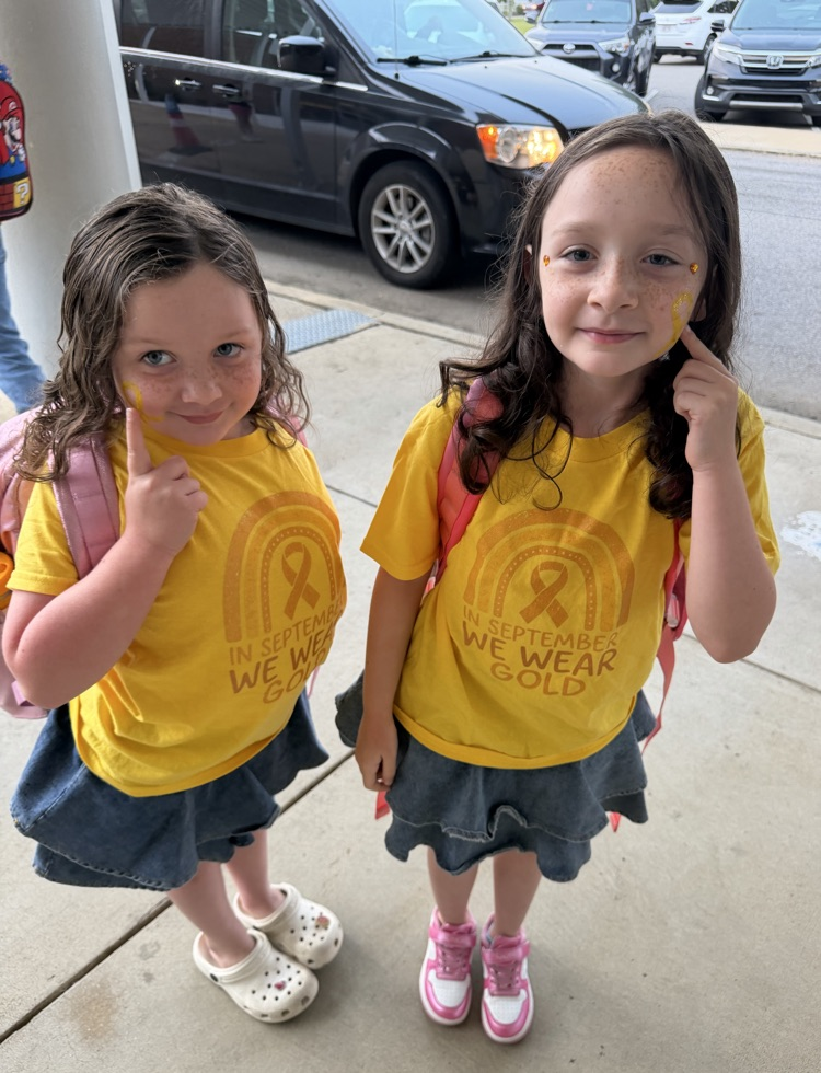 two sisters with give hope shirts and ribbons painted on their faces
