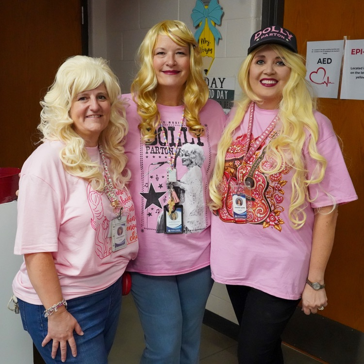 Three teachers dressed up as Dolly Parton to celebrate 9/25.