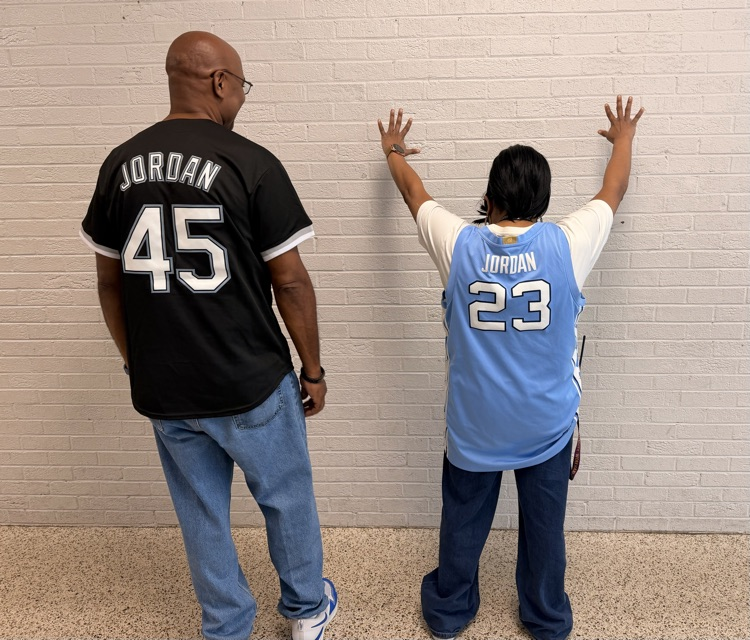 Two HMS staff members show the backs of their Jordan jerseys, numbered 45 and 23.