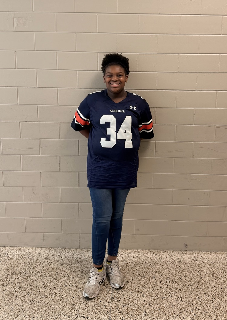 HMS student smiles while wearing a navy Auburn football jersey with number 34.