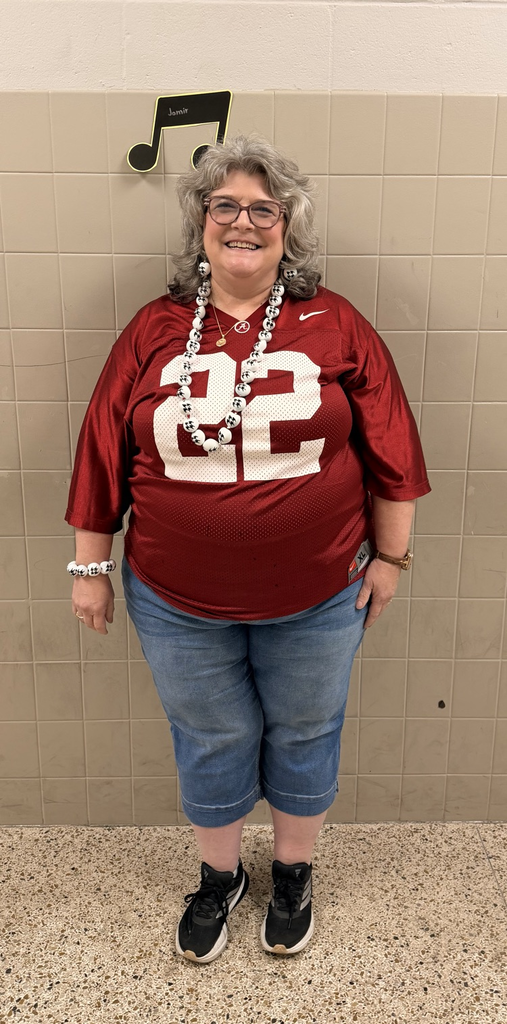 HMS staff member smiles while wearing a crimson Alabama number 22 football jersey.