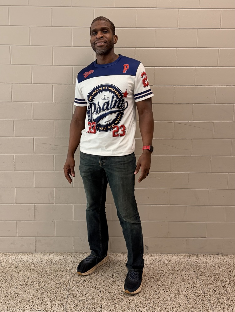 HMS staff member poses in a blue, white, and red sports-style Psalm 23 shirt.