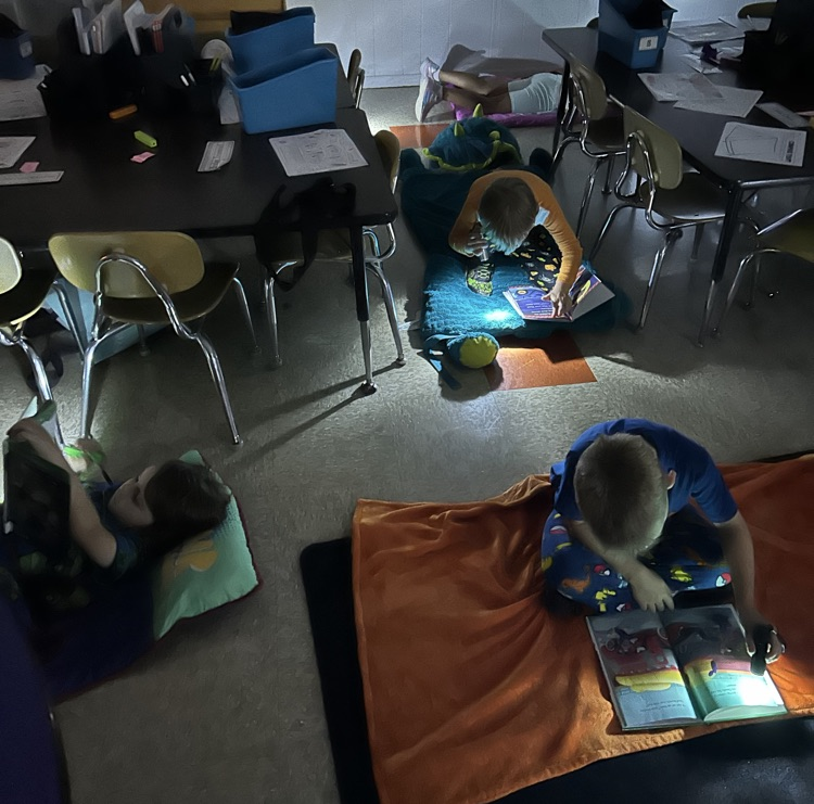 Students reading by flashlights