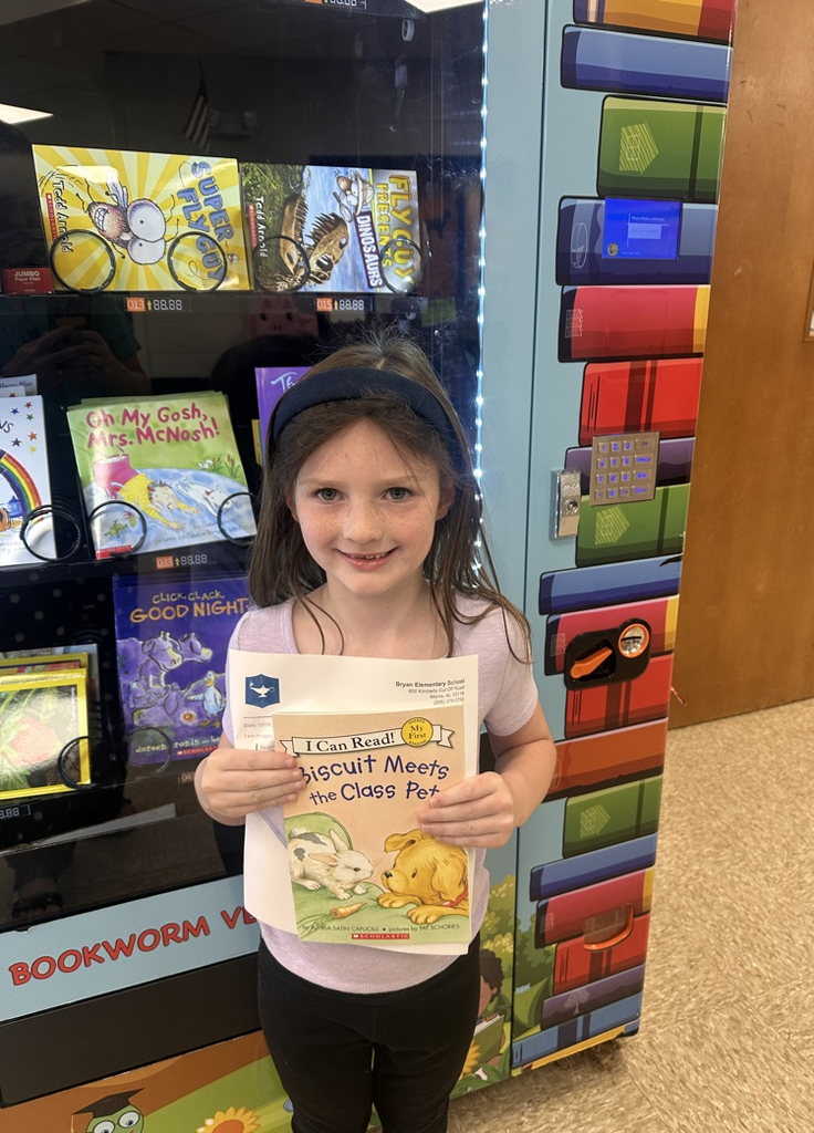 Girl holding a book and smiling