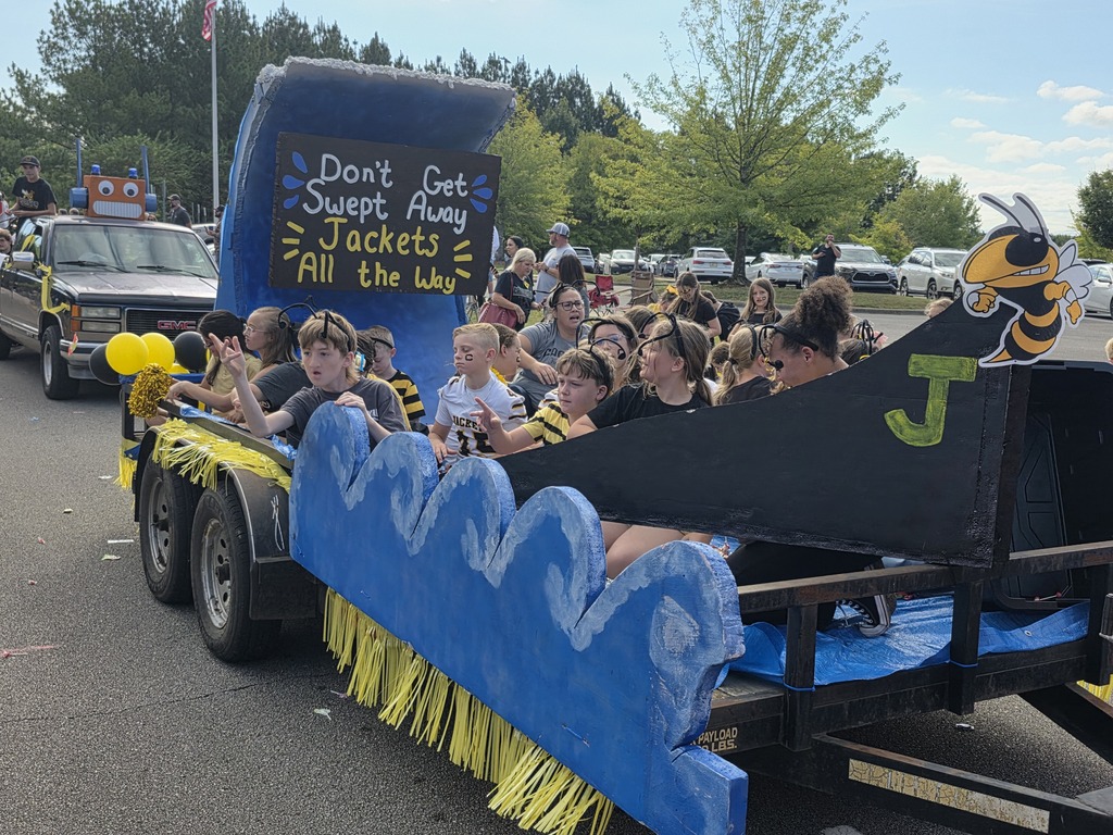 students riding on a parade float