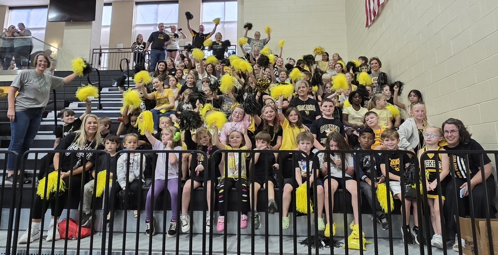 large group of students and teachers sitting in the bleachers