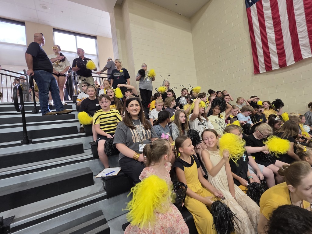 group of students sitting in the bleachers