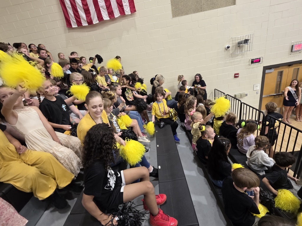 group of students sitting in the bleachers