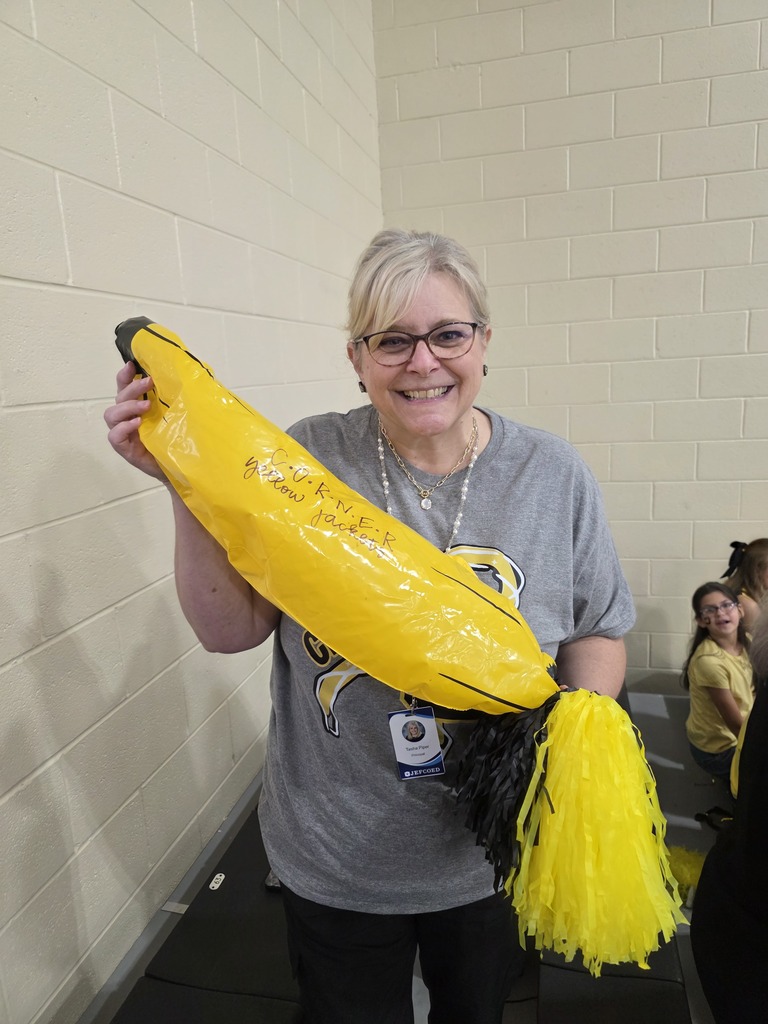 The principal holding the spirit banana