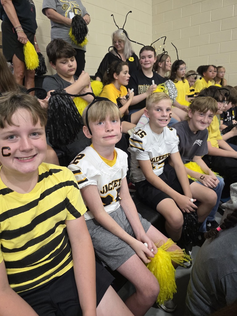group of students sitting in the bleachers