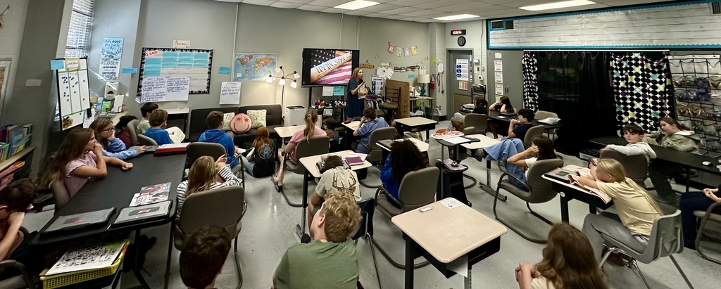Woman teaching 5th graders in the class about the Constitution.