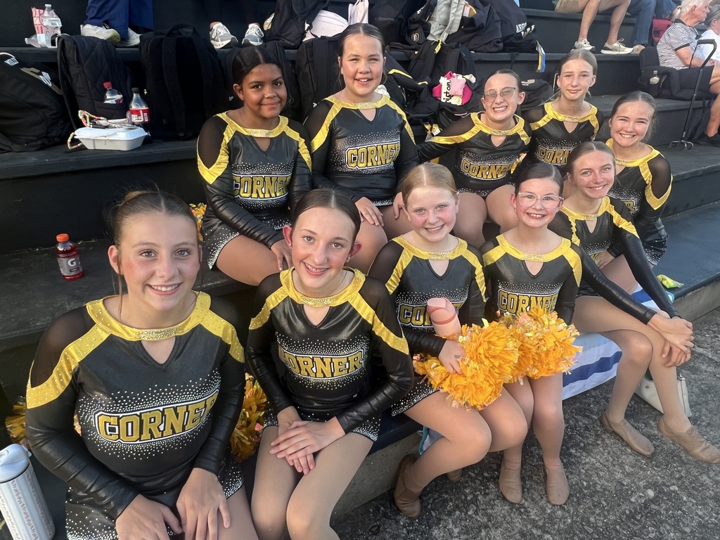 Dance team in black and gold uniforms in the stadium