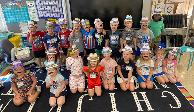 class of students in mustaches and detective hats