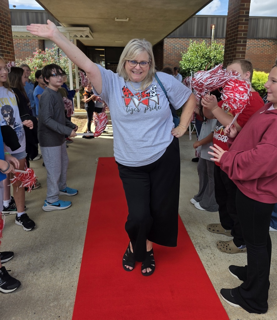 The principal posing on the red carpet