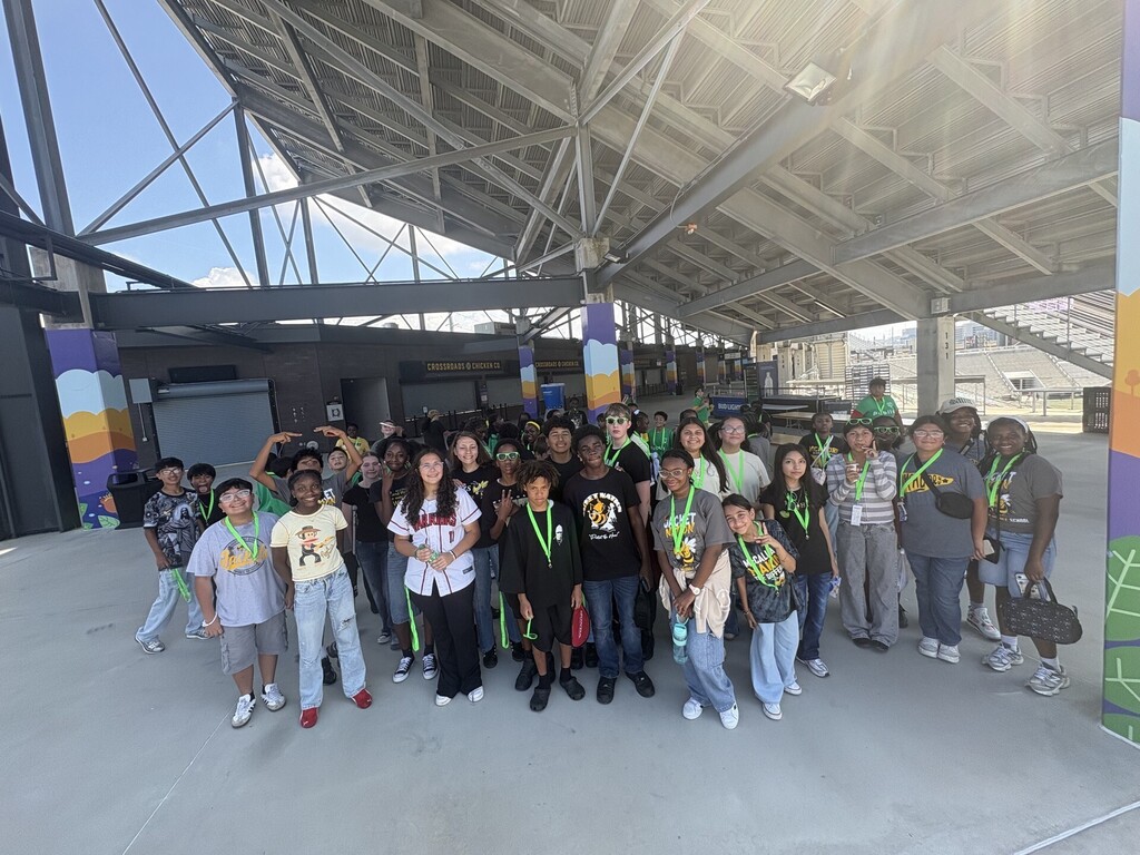 Large group of McAdory students posing together on the concourse at Protective Stadium.