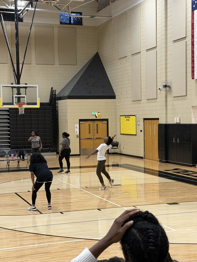 McAdory teacher serving a volleyball in the gym during the Students vs. Teachers game.