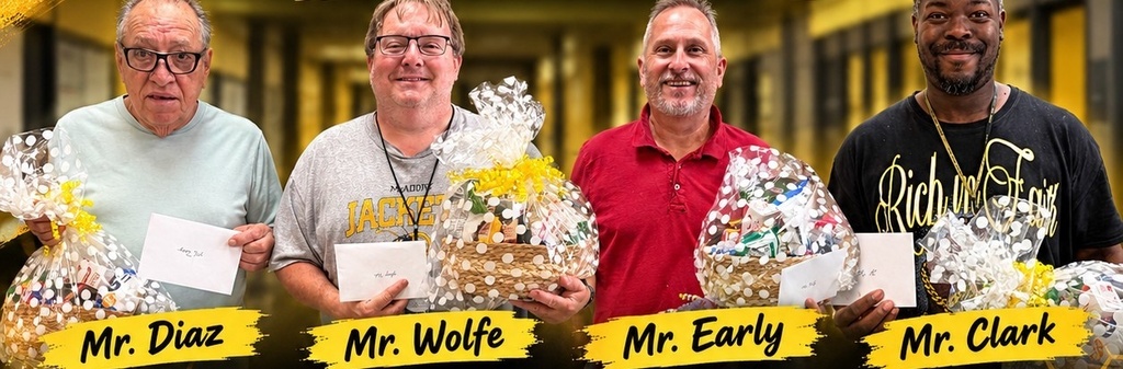 McAdory custodians Mr. Diaz, Mr. Wolfe, Mr. Early, and Mr. Clark smiling and holding appreciation gift baskets and cards in a school hallway.