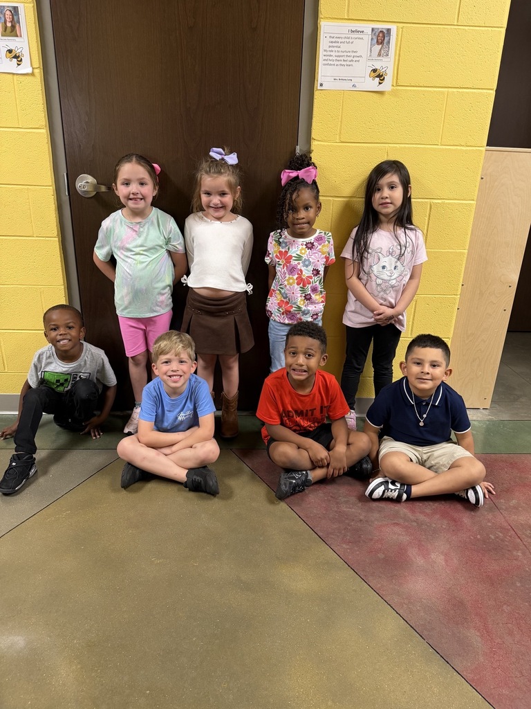 Group photo of the Kindergarten Students of the Month smiling together and being recognized for their positive behavior, leadership, and hard work at school.