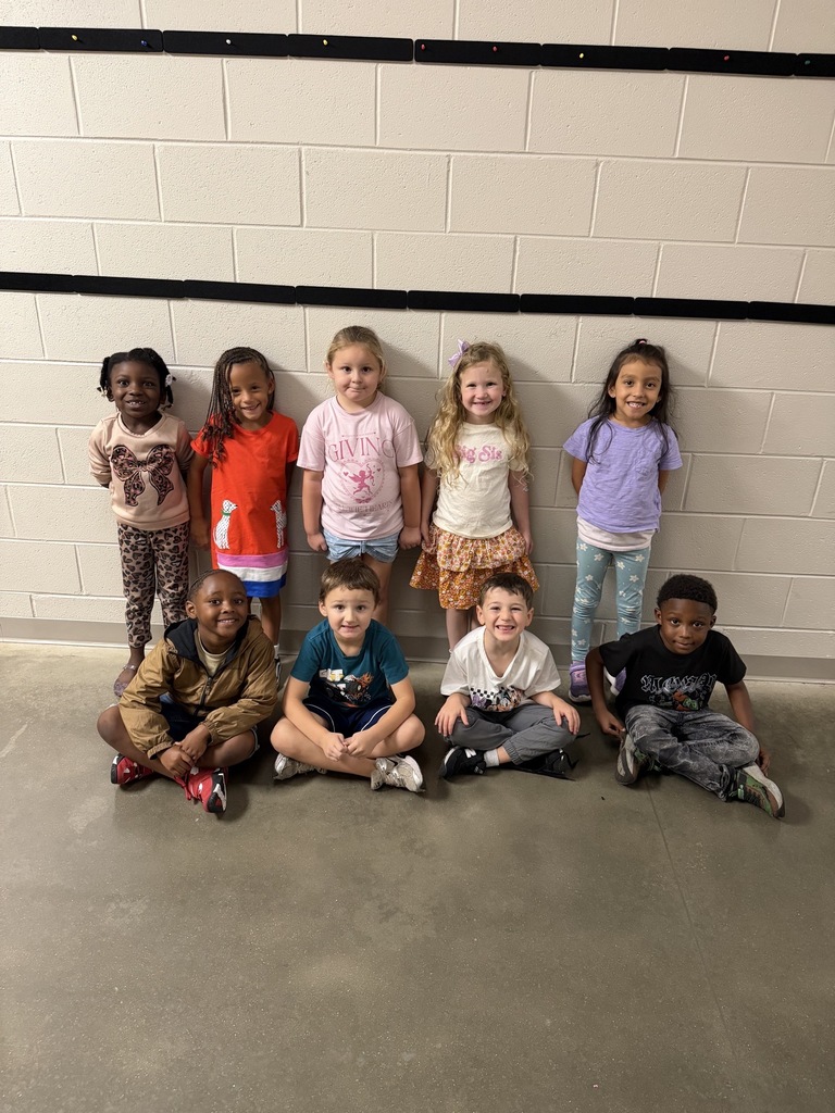 Group photo of the Kindergarten Students of the Month smiling together and being recognized for their positive behavior, leadership, and hard work at school.