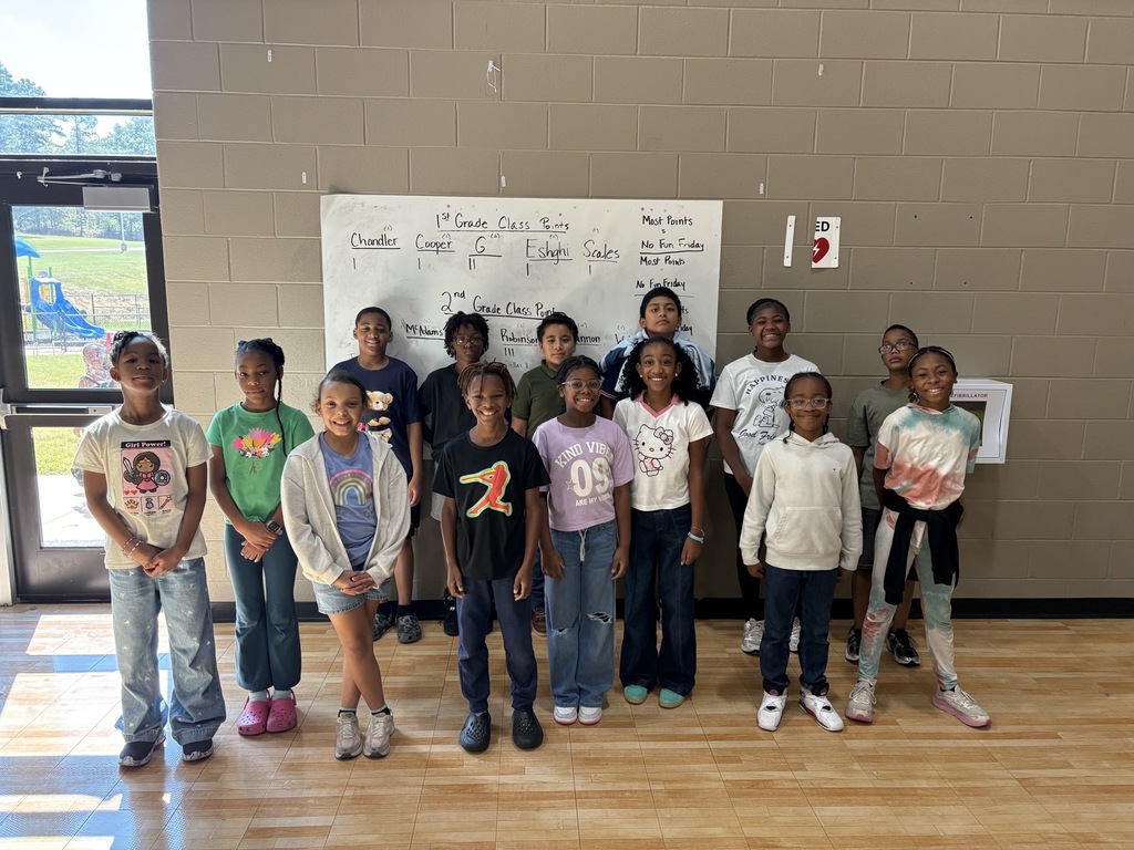 Group photo of the Fourth Grade Students of the Month smiling together and being recognized for their positive behavior, leadership, and hard work at school.