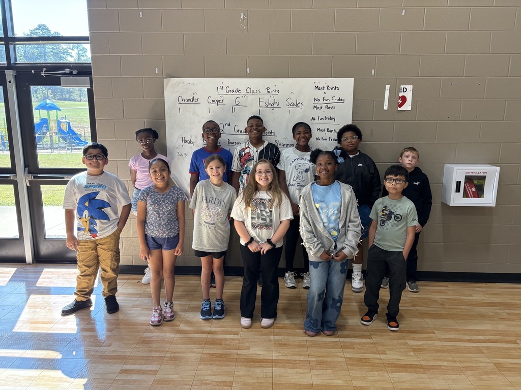 Group photo of the Fourth Grade Students of the Month smiling together and being recognized for their positive behavior, leadership, and hard work at school.