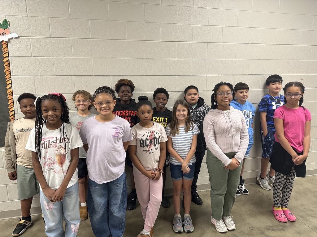 Group photo of the Fifth Grade Students of the Month smiling together and being recognized for their positive behavior, leadership, and hard work at school.