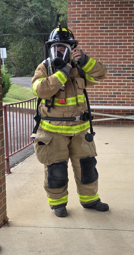 a lady firefighter dressed in full gear