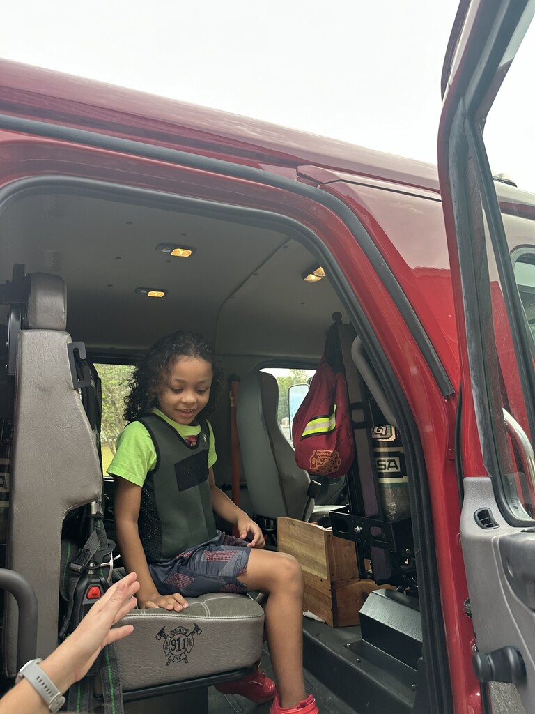 a student sitting in the backseat of the firetruck