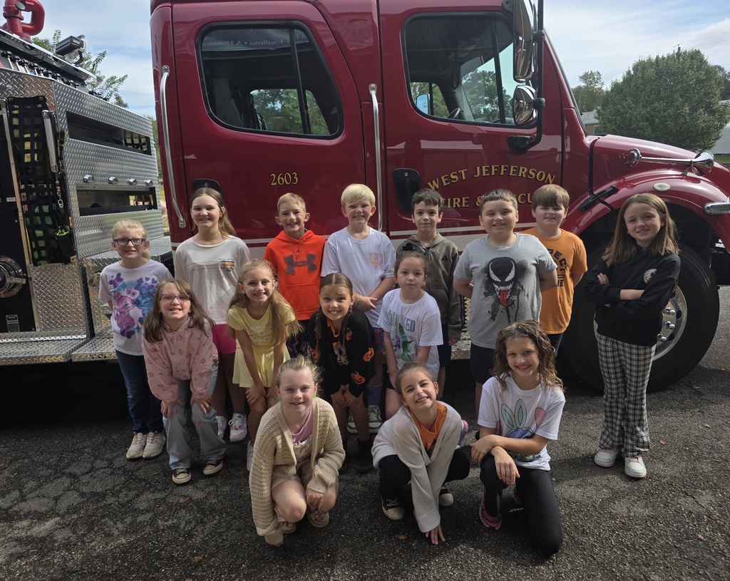 students standing in front of a fire truck