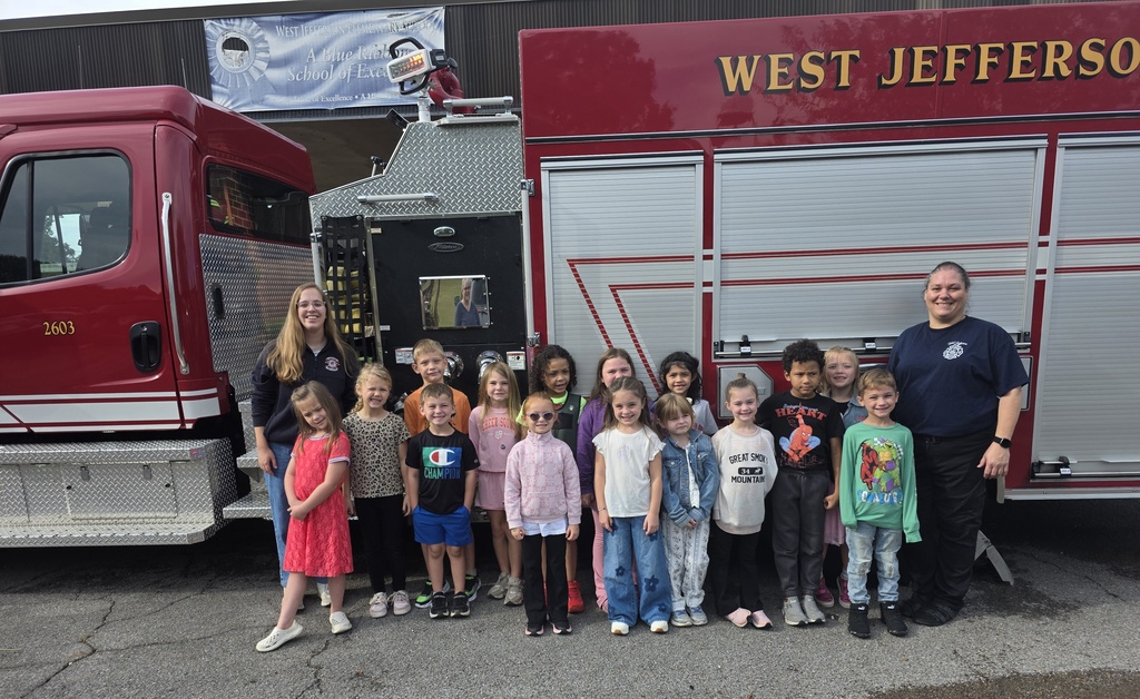 students standing in front of a fire truck