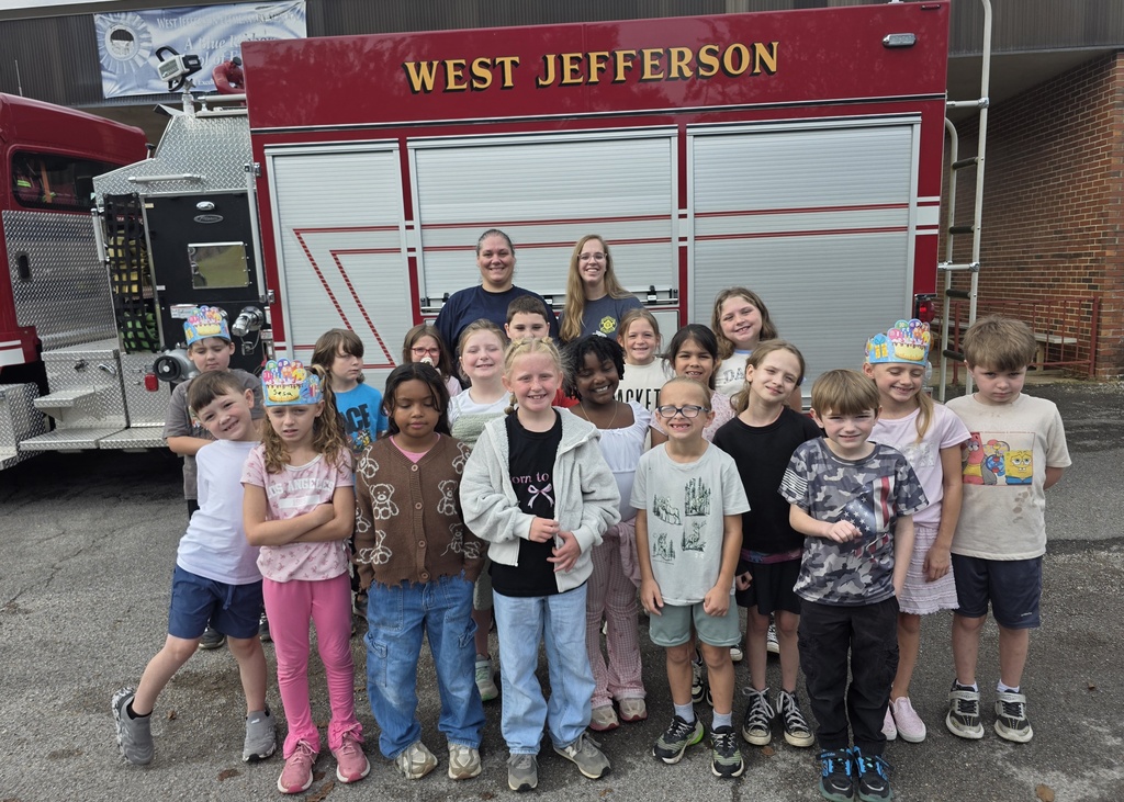 students standing in front of a fire truck