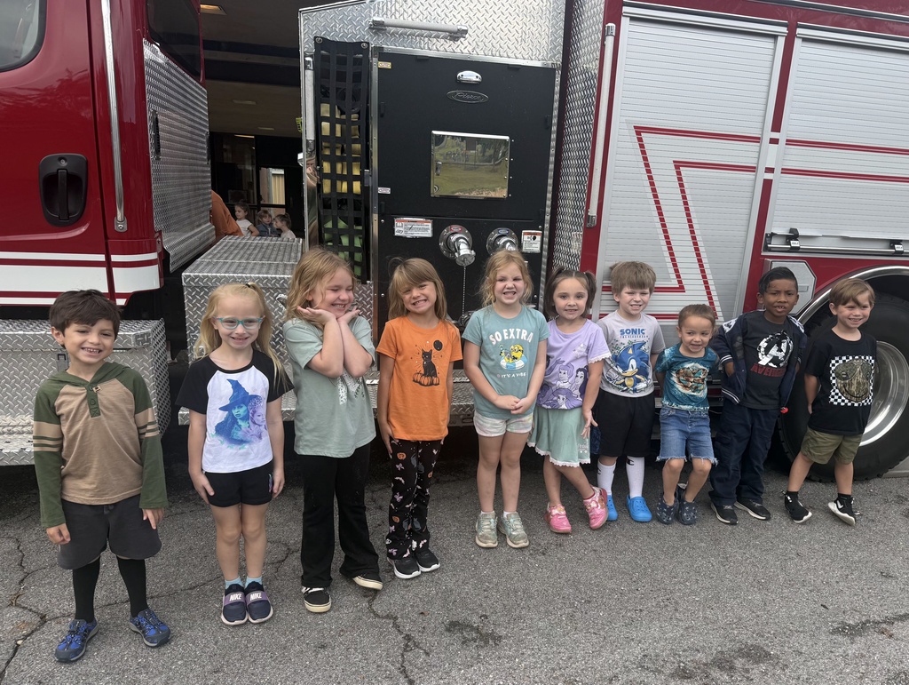students standing in front of a fire truck
