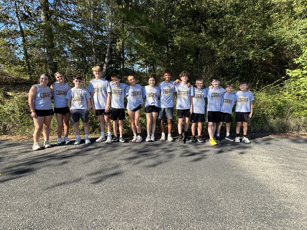 Cross country runners outside in front of trees