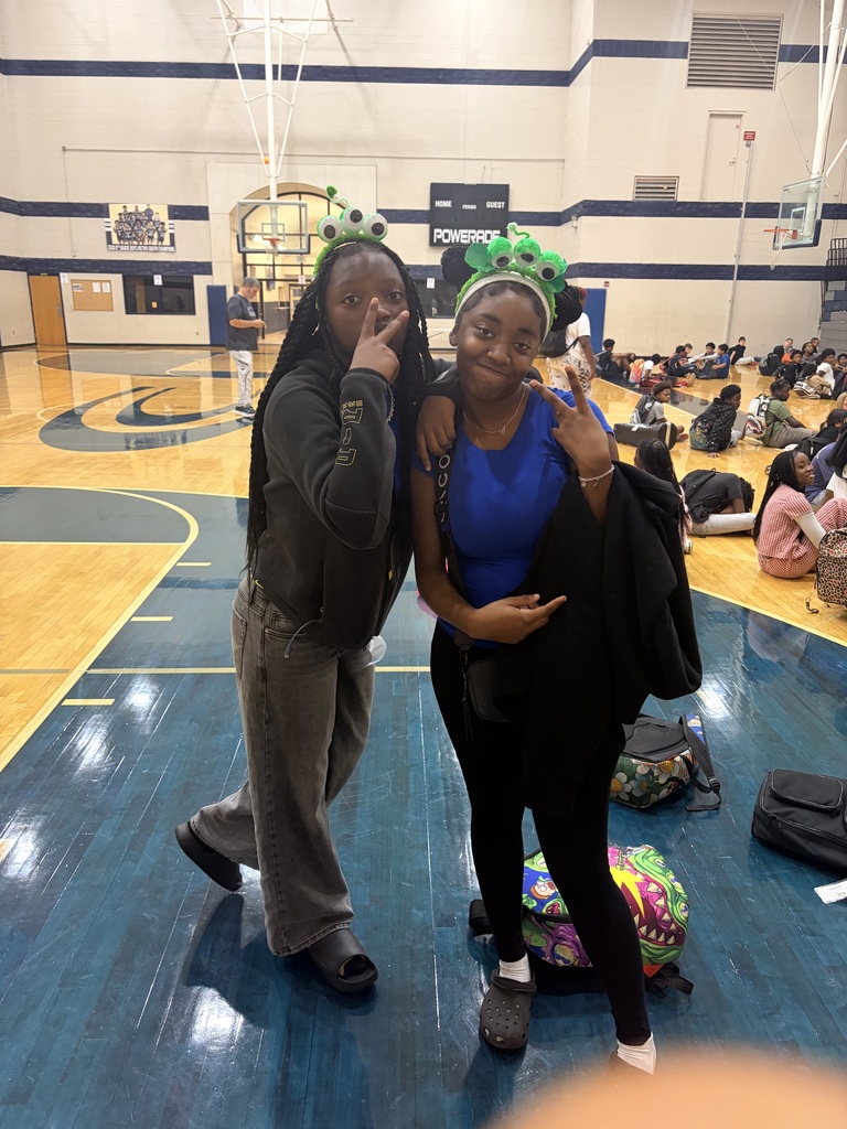Two girls wearing headbands with wiggle eyes