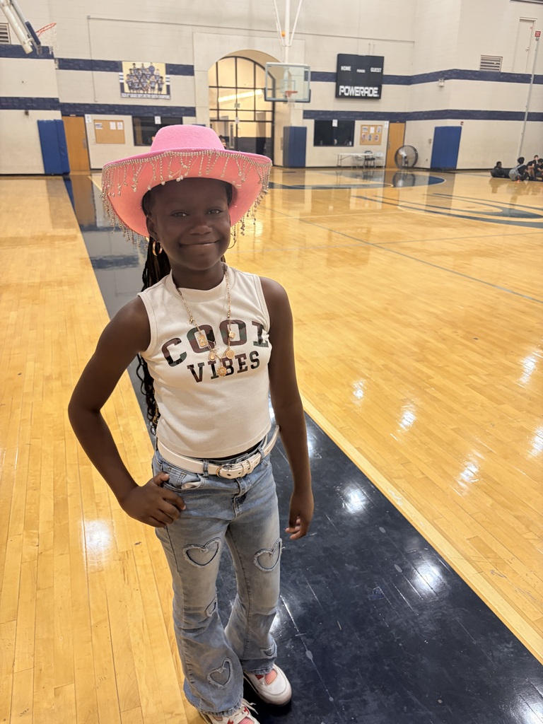 Young lady wearing pink cowgirl hat with hanging gems