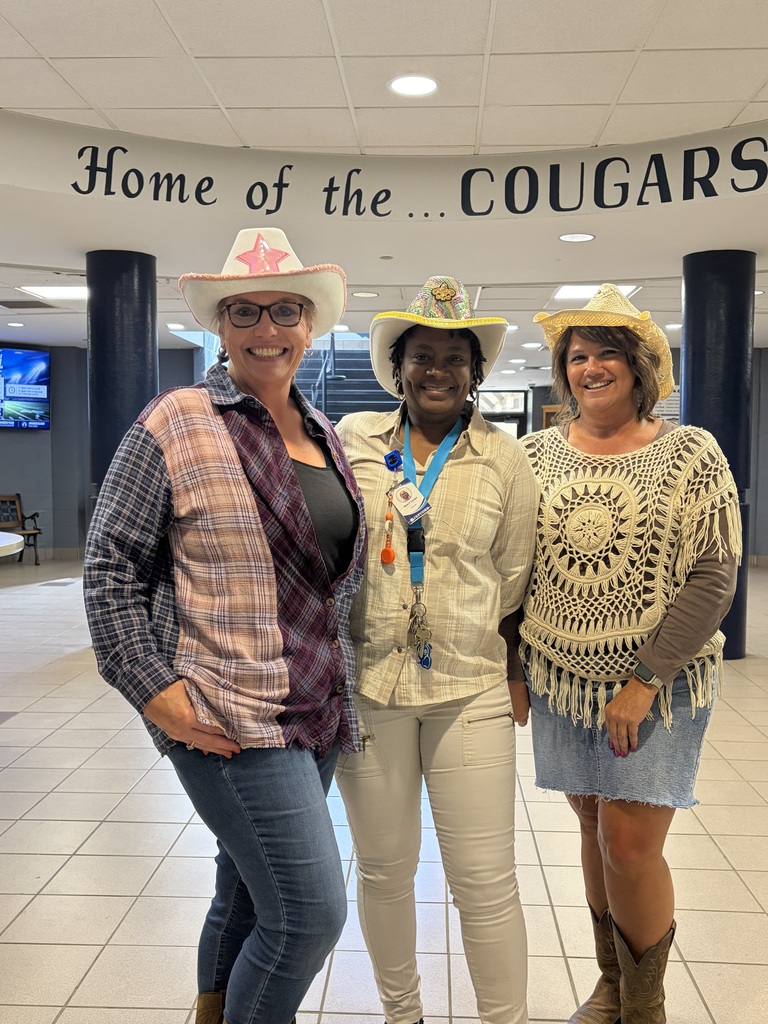 Three women wearing cowgirl gear.