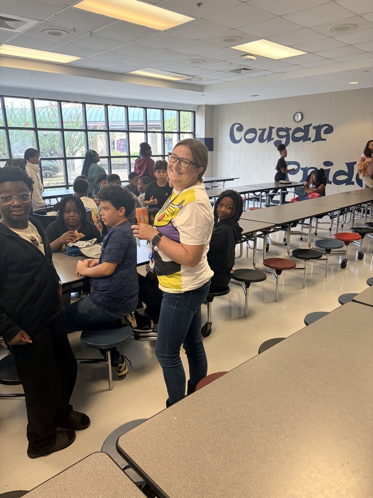 Teacher in cafeteria with students wearing space ranger