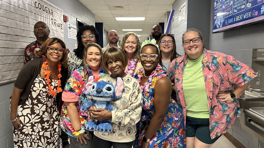 Group of teachers taking pictures in tropical wear