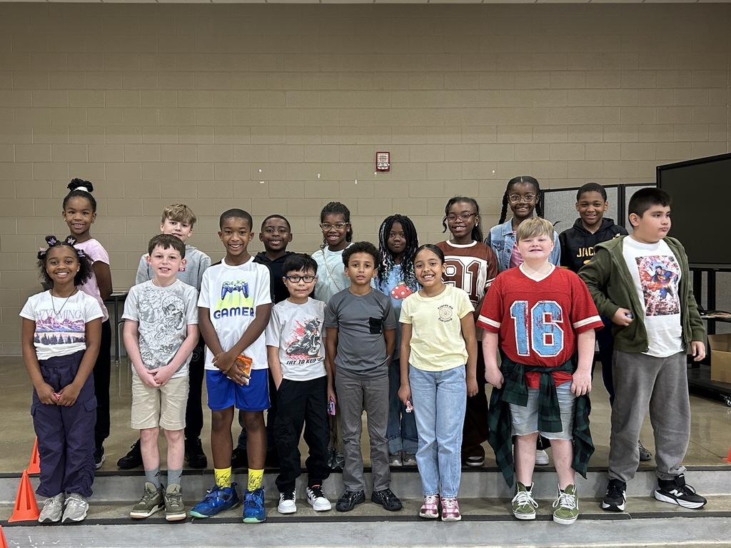Group photo of McCalla Elementary fourth-grade students celebrating their success in meeting mCLASS and i-Ready benchmark goals.