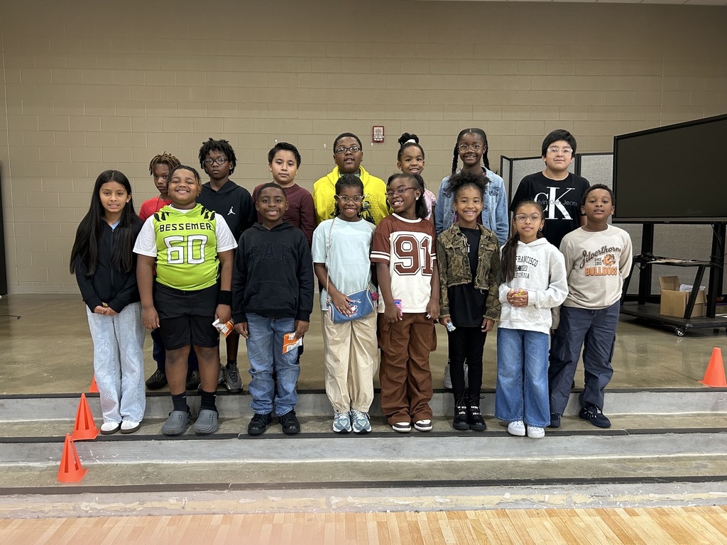 Group photo of McCalla Elementary fourth-grade students celebrating their success in meeting mCLASS and i-Ready benchmark goals.