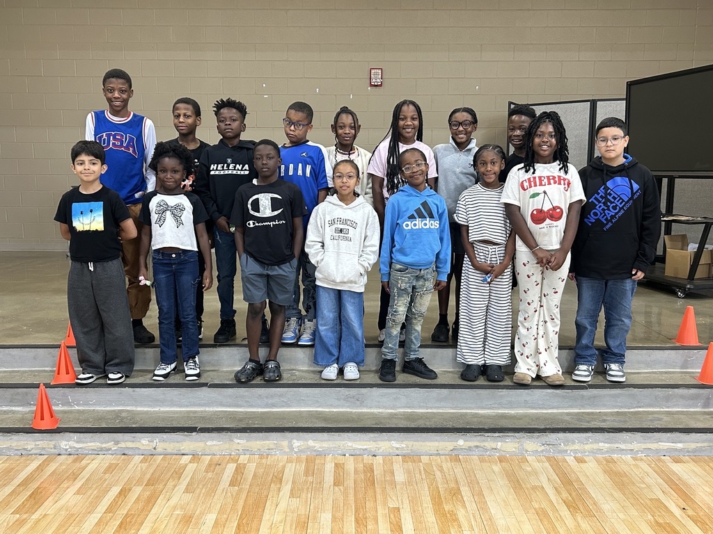 Group photo of McCalla Elementary fourth-grade students celebrating their success in meeting mCLASS and i-Ready benchmark goals.
