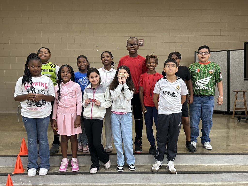 Group photo of McCalla Elementary fourth-grade students celebrating their success in meeting mCLASS and i-Ready benchmark goals.