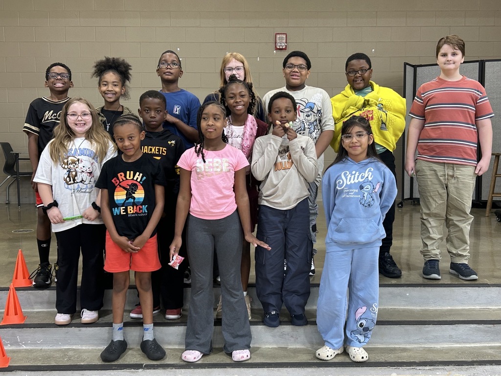 Group photo of McCalla Elementary fourth-grade students celebrating their success in meeting mCLASS and i-Ready benchmark goals.